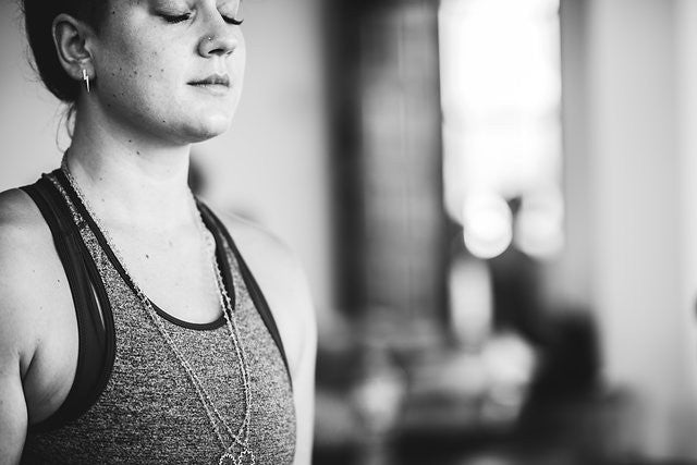 Woman meditating with eyes closed