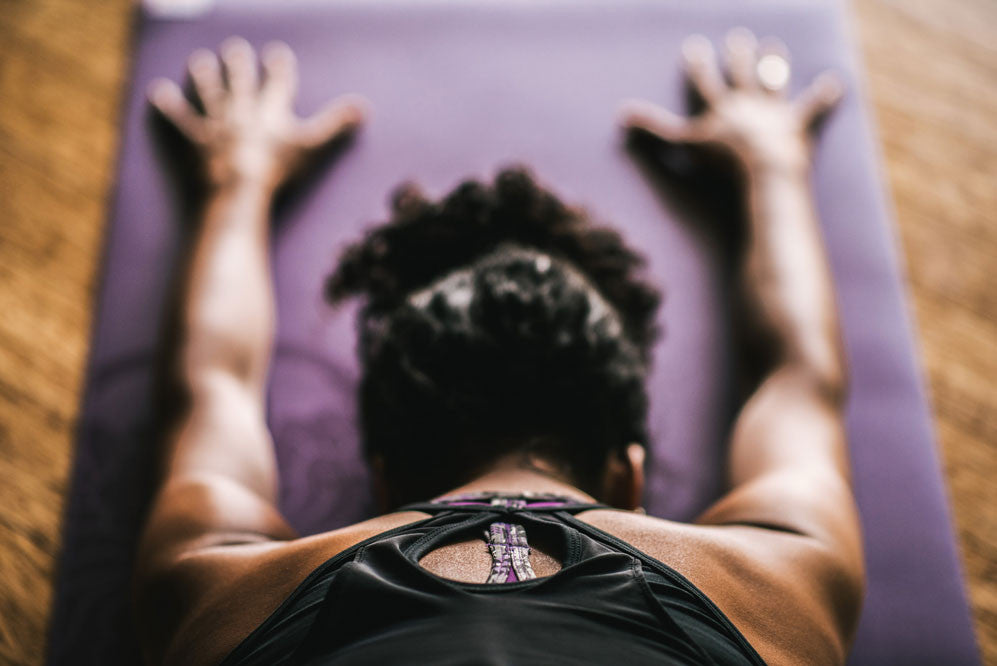 Woman doing child's pose on yoga mat