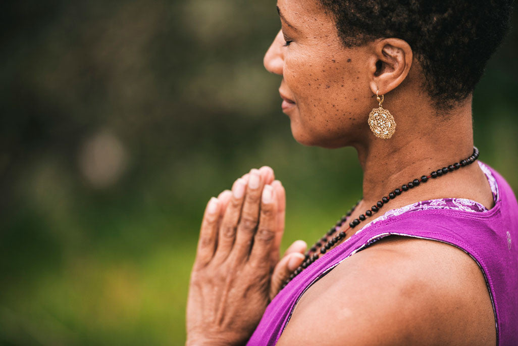 Woman breathing in prayer pose