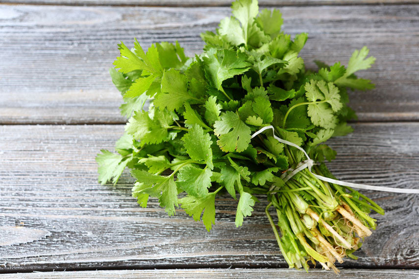 a bundle of herbs on a wood table
