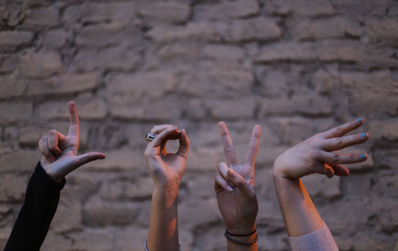 Hands spelling out the word "Love"