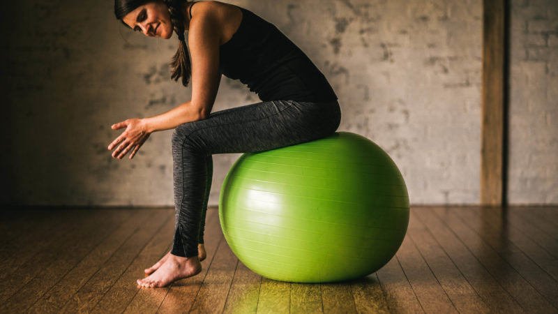 Woman sitting on balance ball