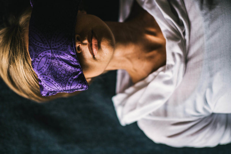 Woman with an eye pillow over her eyes