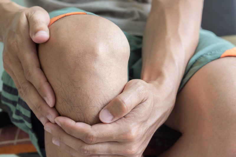 Man holding his knee