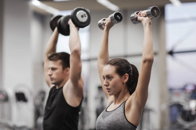 man and woman lifting weights