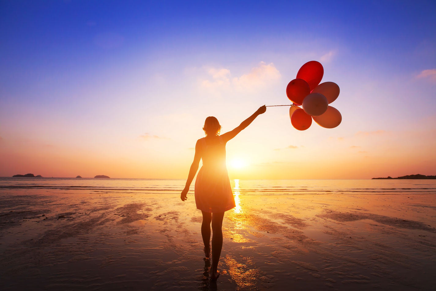 Girl holding balloons