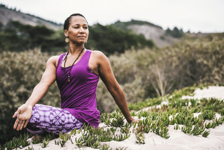 Woman sitting on a sandy hill