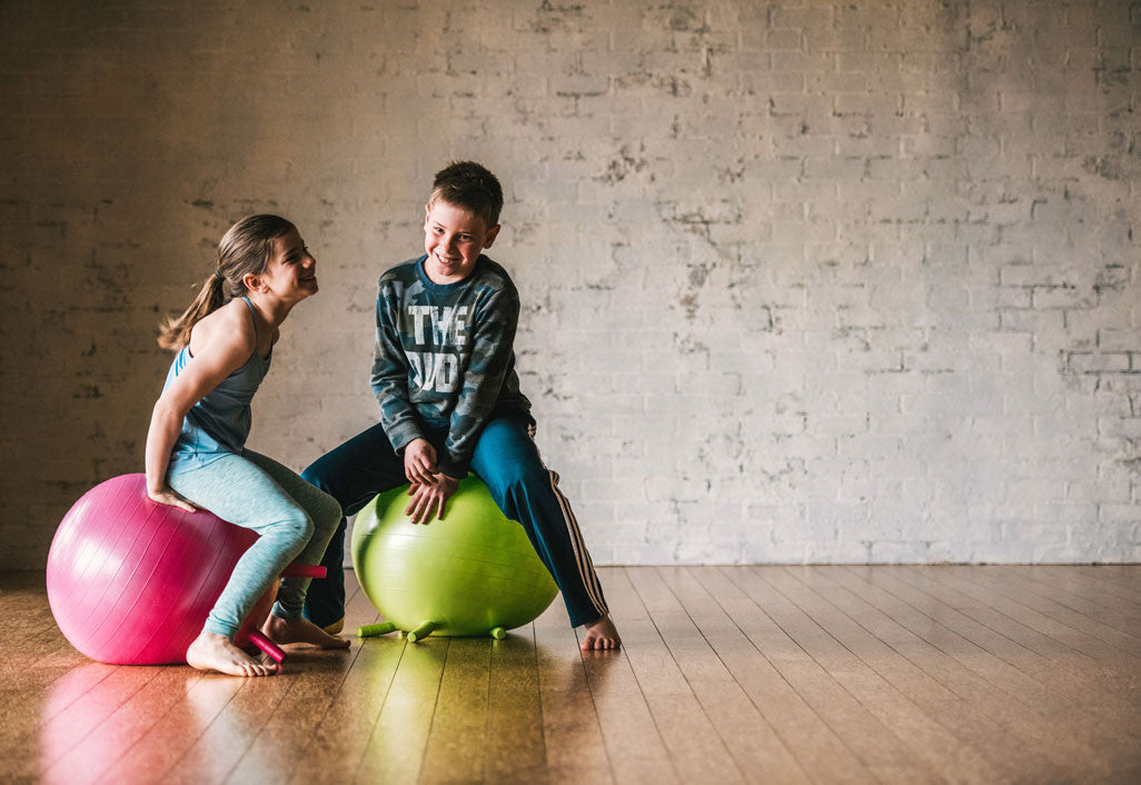 Kids bouncing on Gaiam Kid's Stay-N-Play Ball