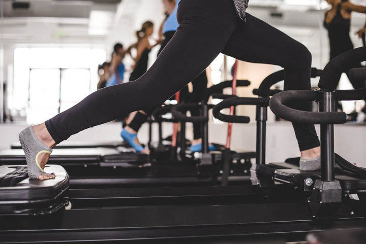 Women on Pilates reformer machines
