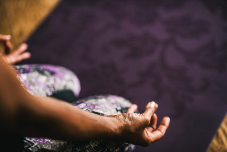 Person kneeling on a yoga mat