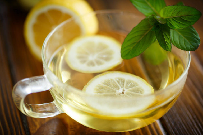 Mug of tea with lemon and mint
