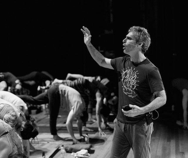 Man teaches yoga class