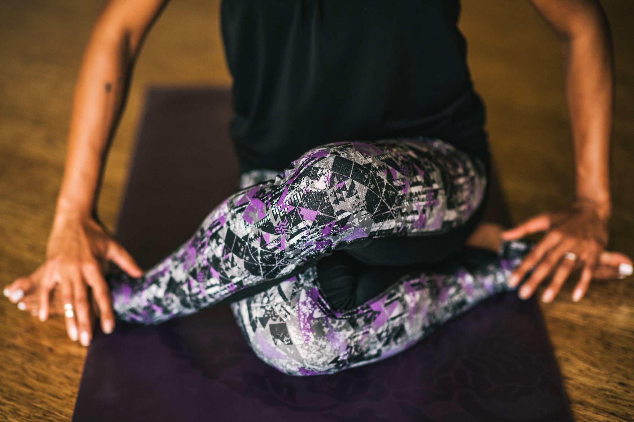 Woman sitting crossed-legged on a yoga mat