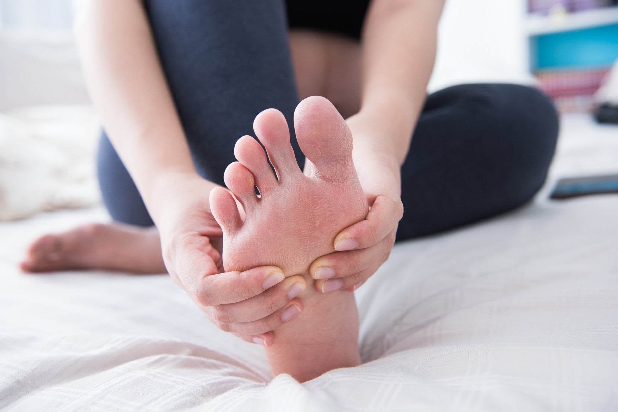 Woman massages the sole of her foot