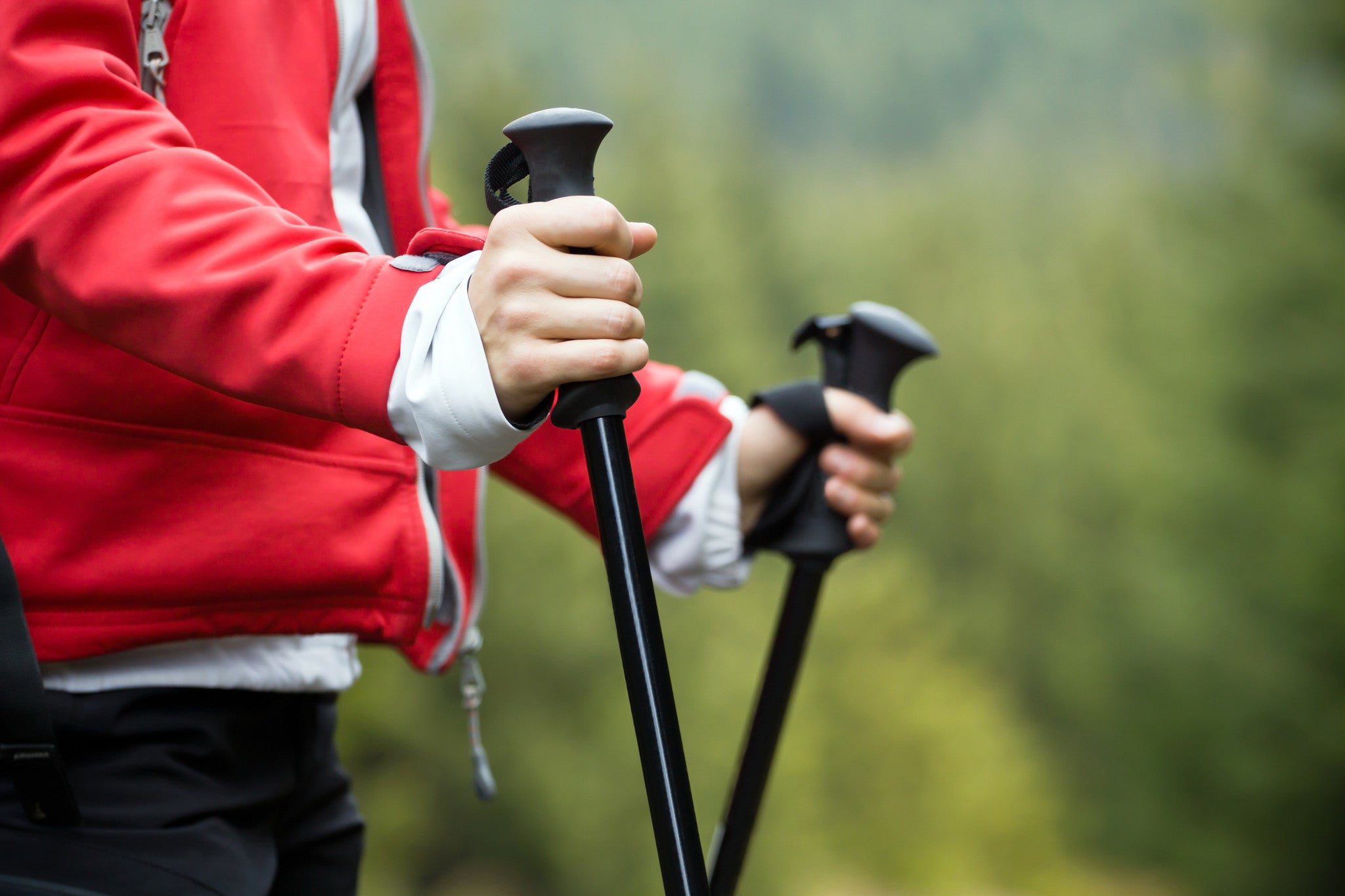 woman outside using walking poles