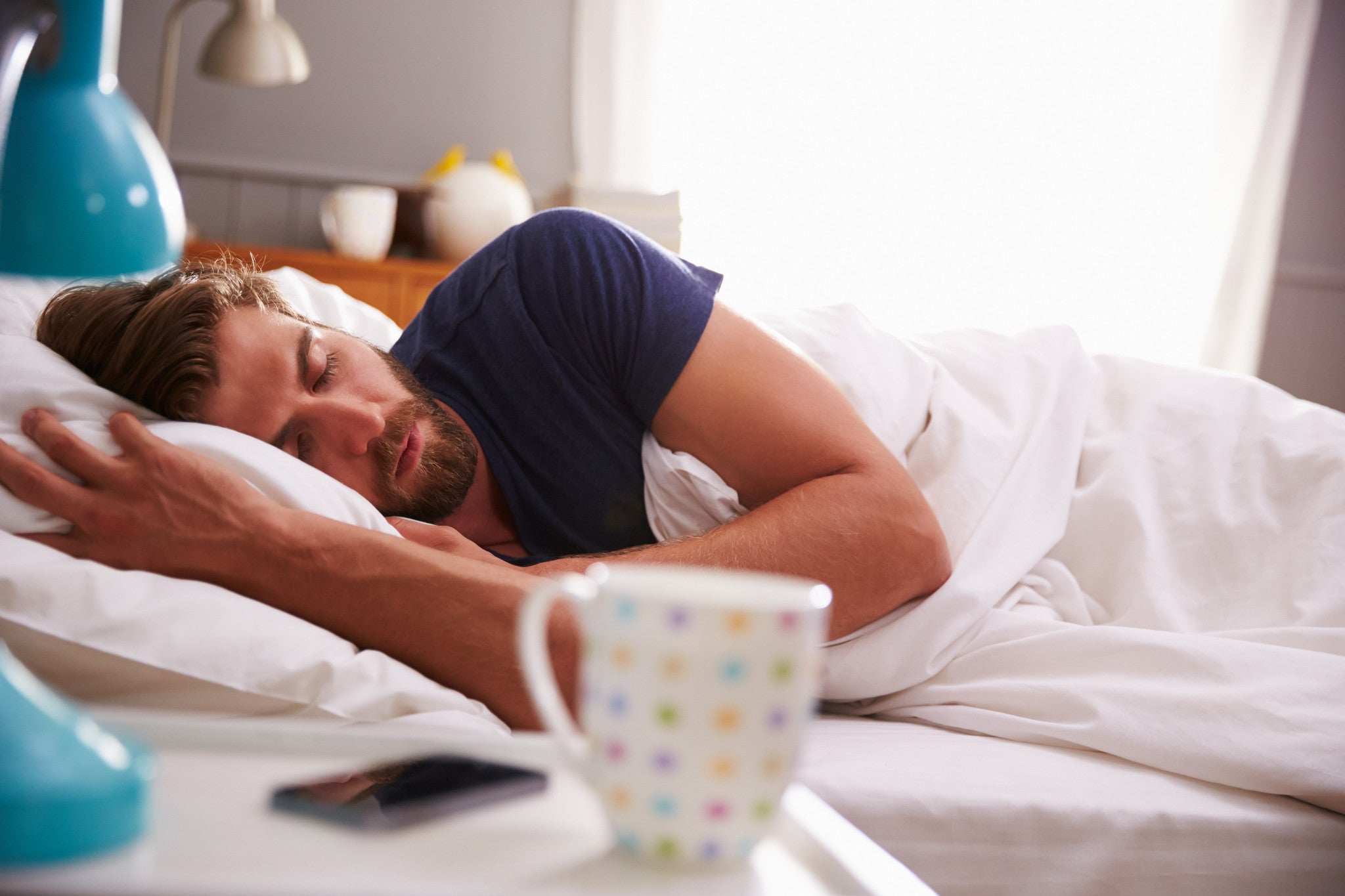 man asleep in bed