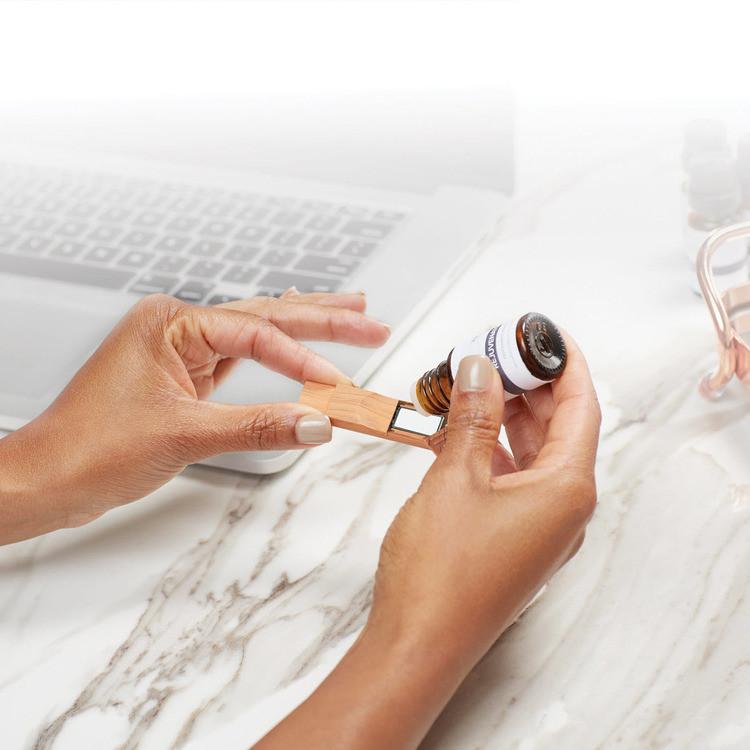 Someone dropping essential oil into Gaiam's Aromatherapy USB Diffuser