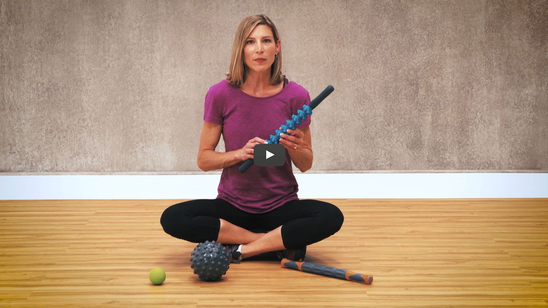woman holds massage tool