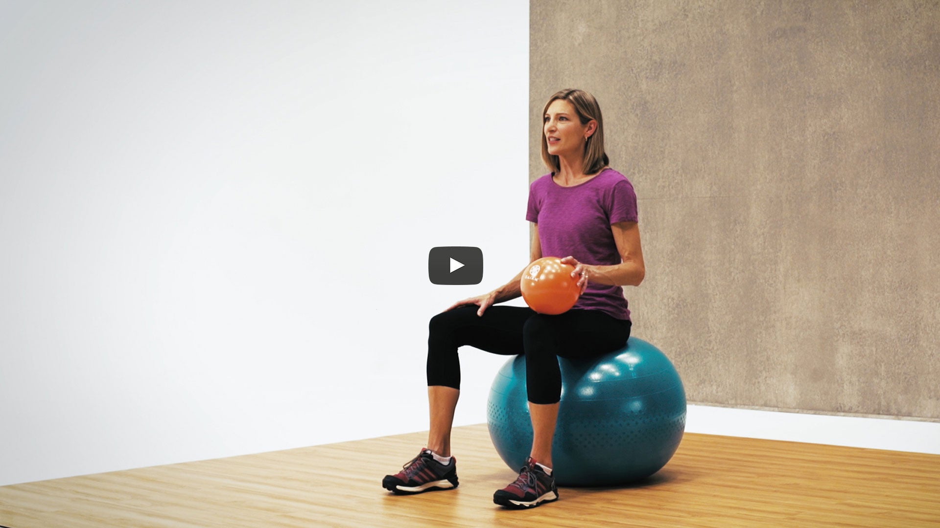 woman sits on blue stability ball