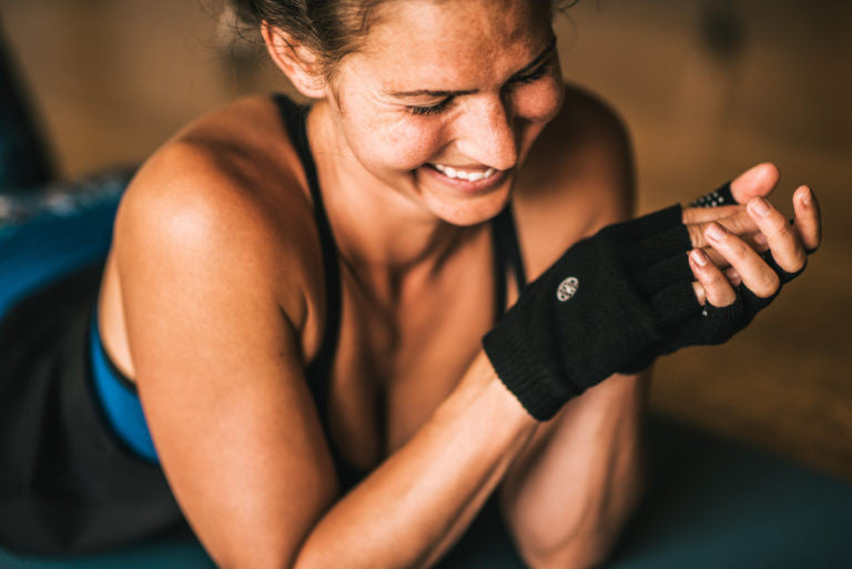 Woman smiling with fingerless gloves on