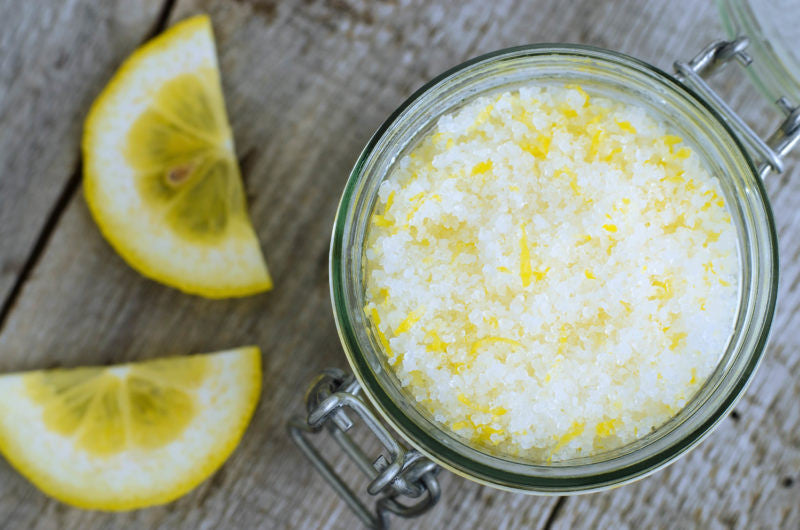 Lemon slices next to a jar with lemon zest