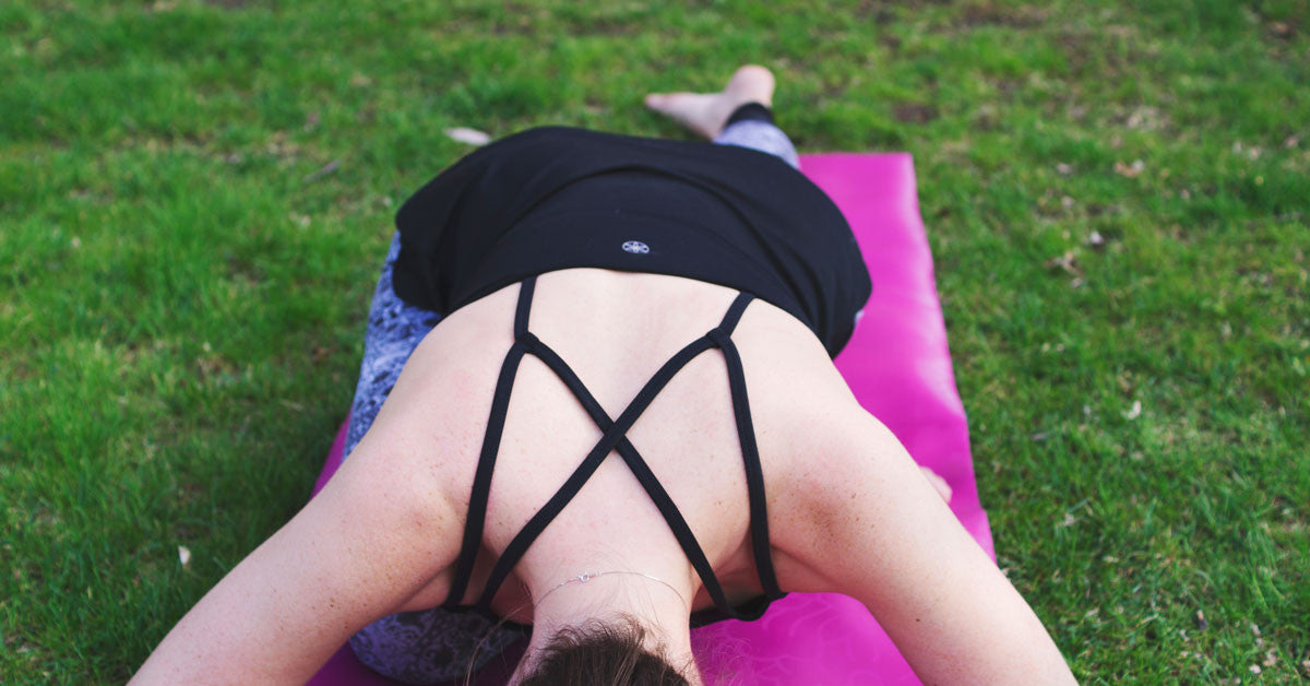 Women bent over in pigeon pose