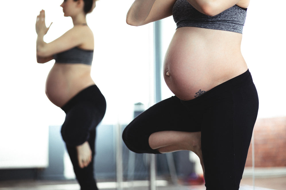 A pregnant woman in tree pose