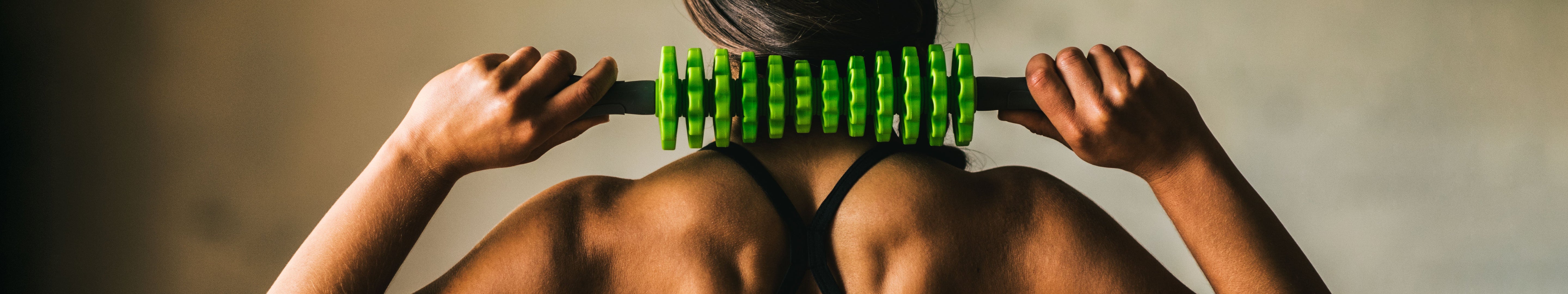 woman massaging neck with roller