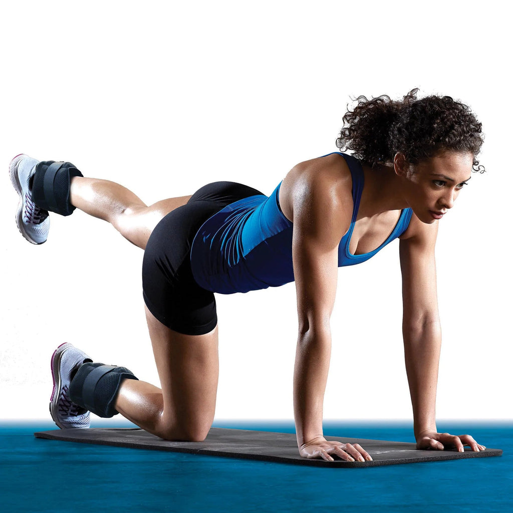 Woman on hands and knee with one leg extended wearing ankle weights