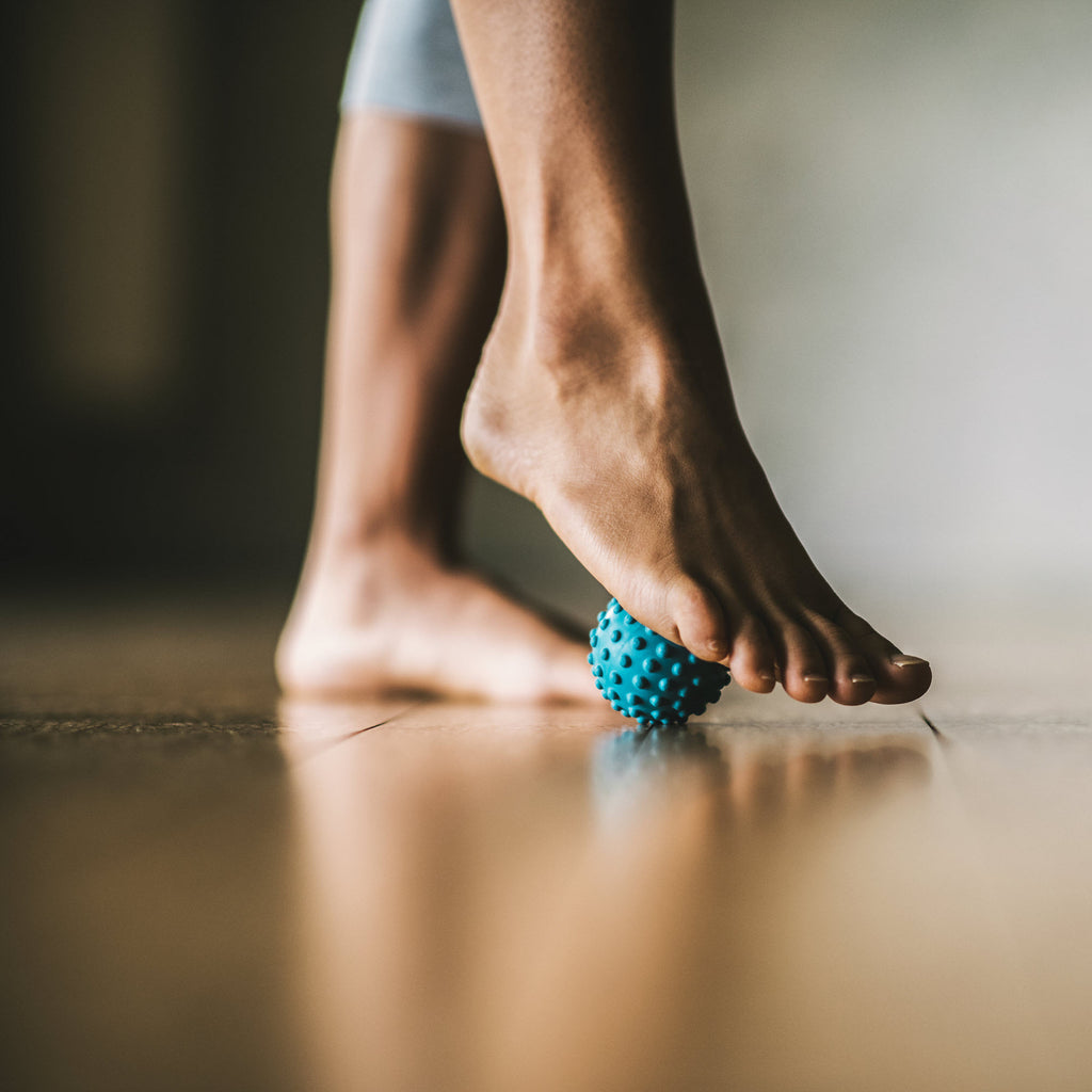 Massaging the ball of the foot with the Ultimate Foot Massager