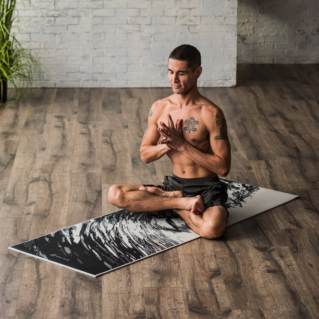 Man in seated meditation on mat