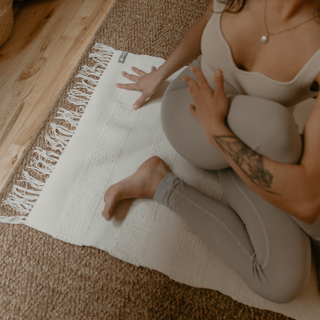 Person sitting on Cotton Practice Rug