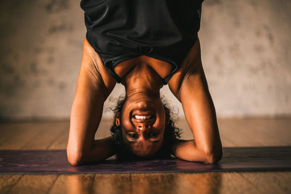 Woman in four-arm stand
