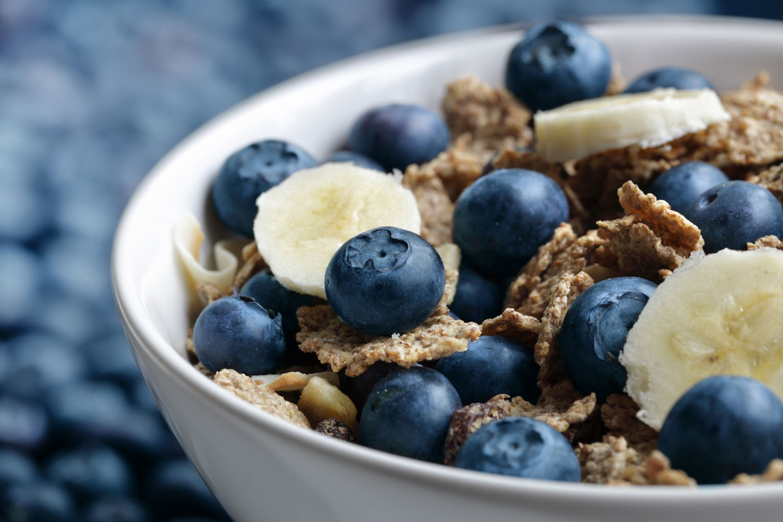 Bowl of granola with banana and blueberries