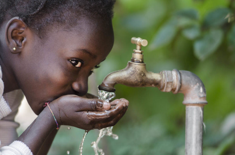 Child drinking water from spout