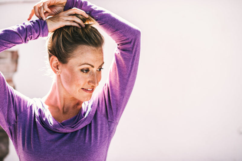 Woman putting her hair in a bun
