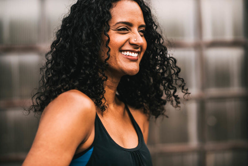Woman smiling with curly dark hair