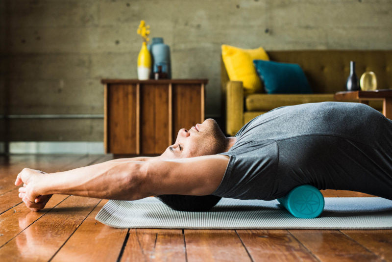 man foam rolling his back