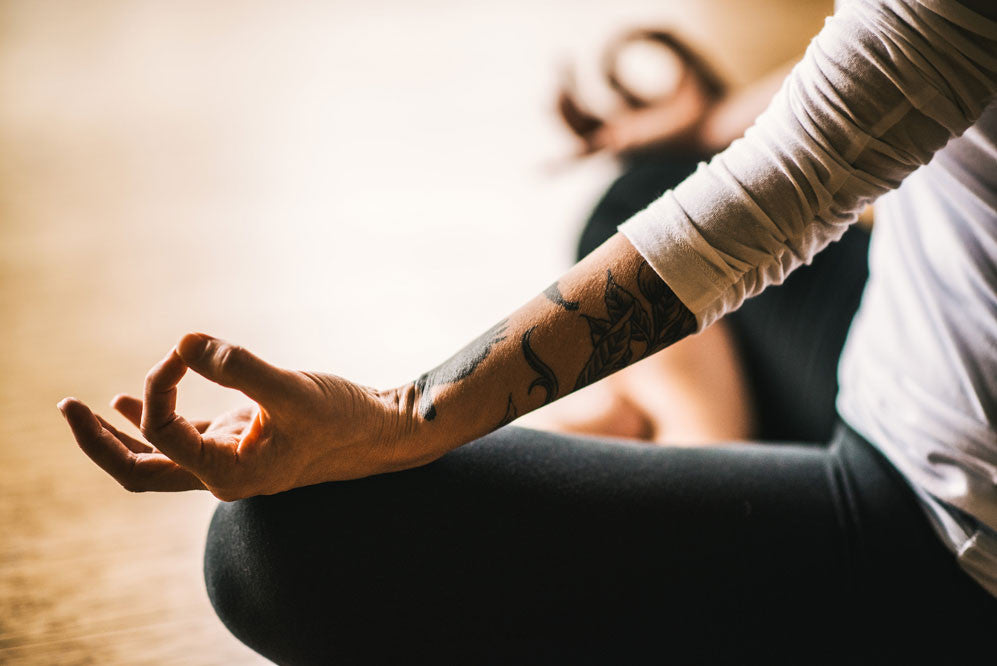 person sits on meditation with hands in mudra