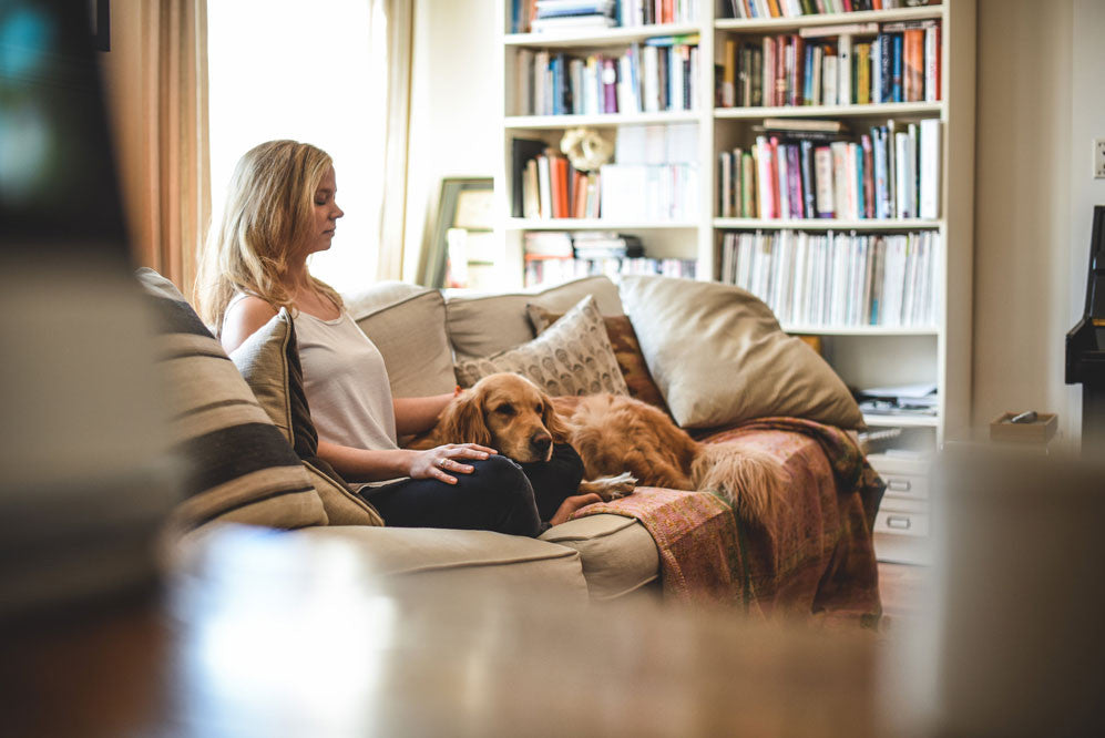 Woman on a couch with her eyes closed 