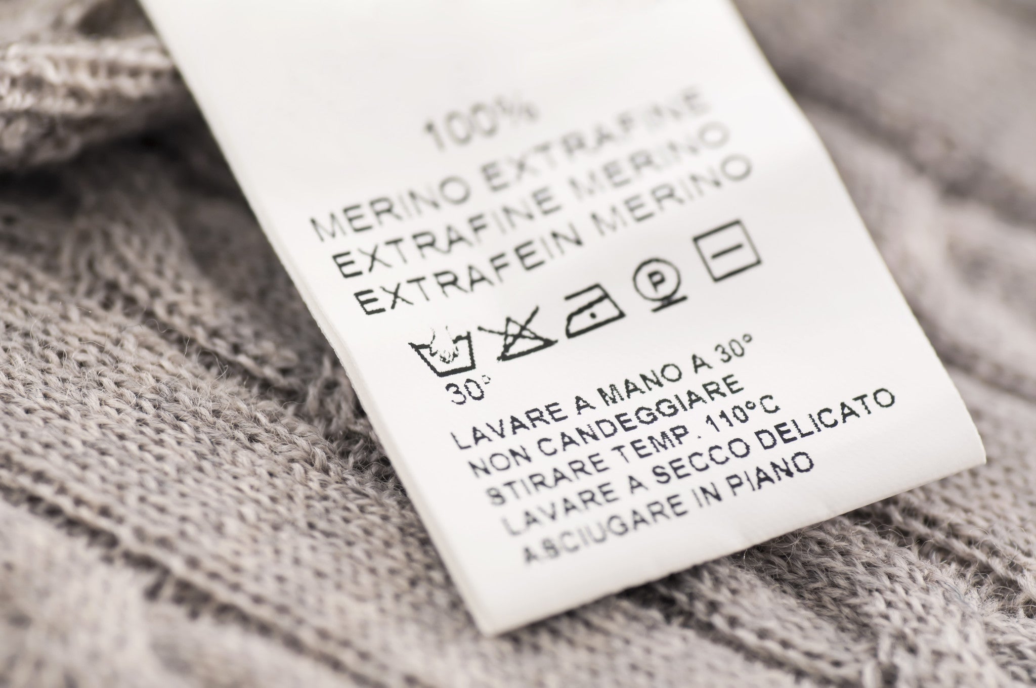 tag with washing instructions on sweater