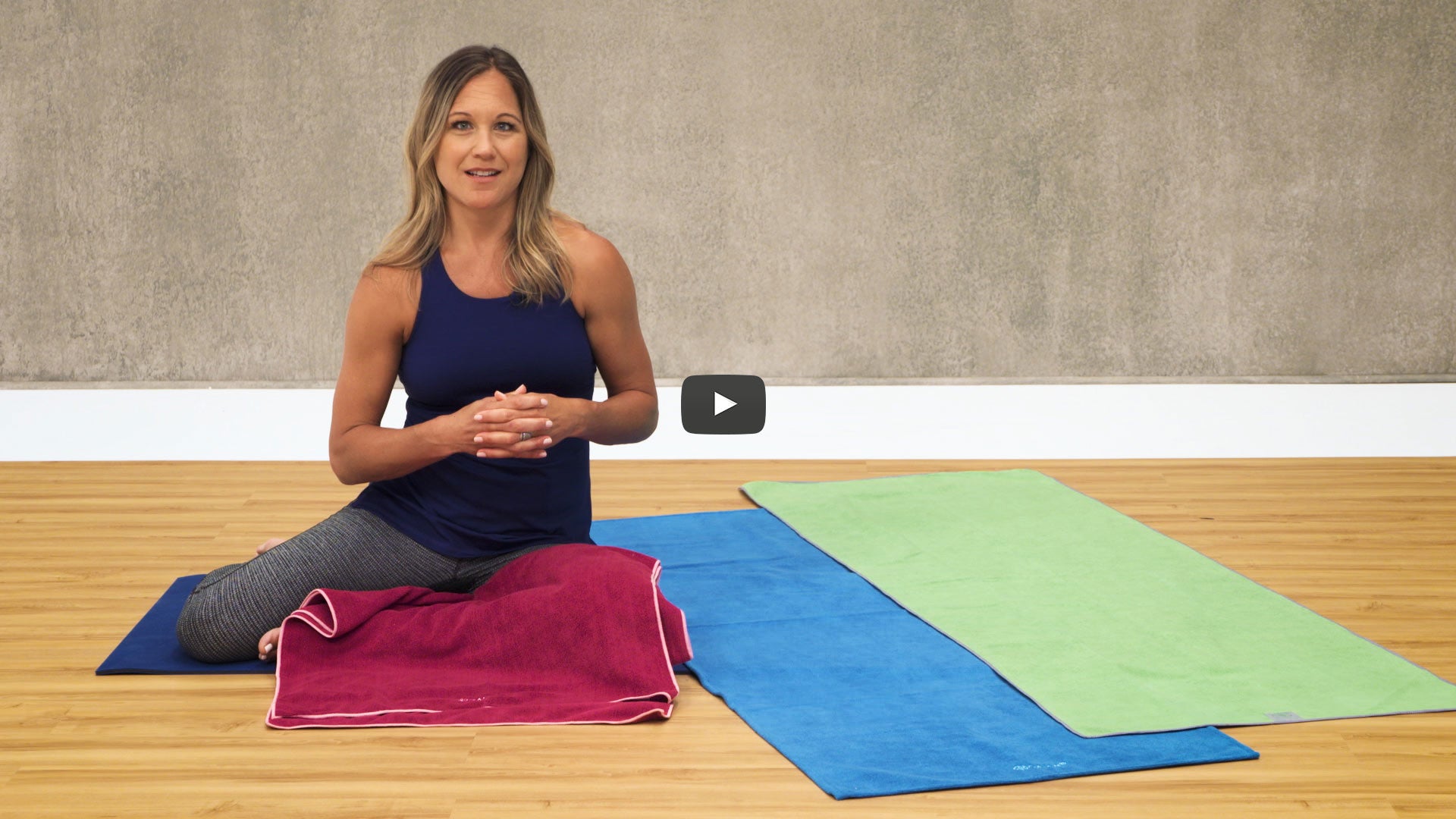 woman with array of yoga towels