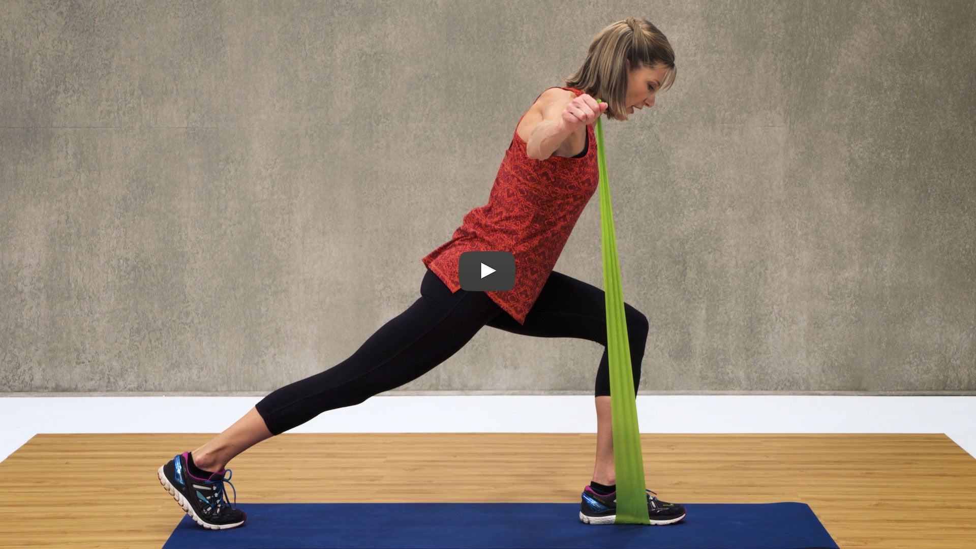 woman lunges using green band