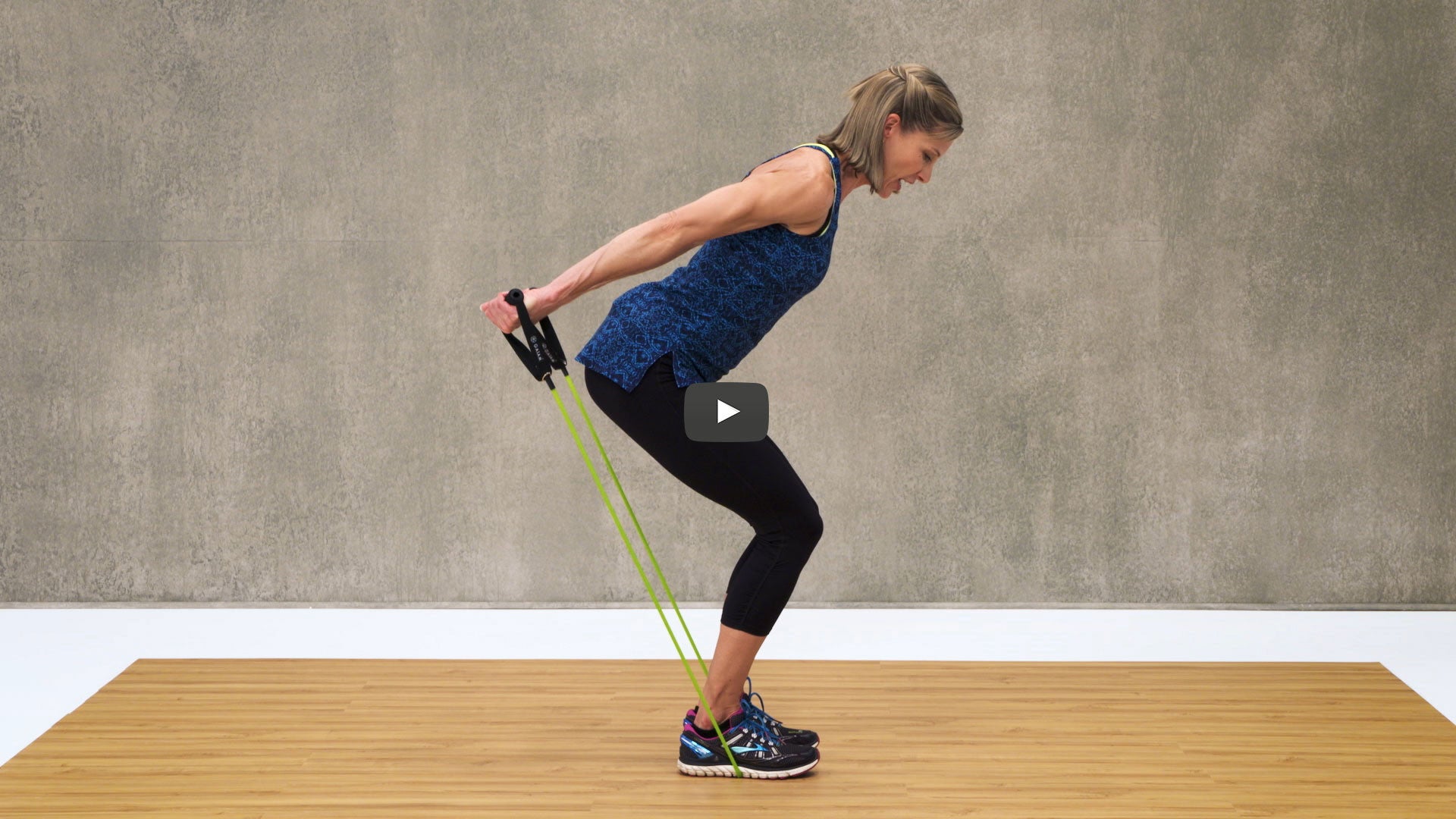 woman squats with resistance cord