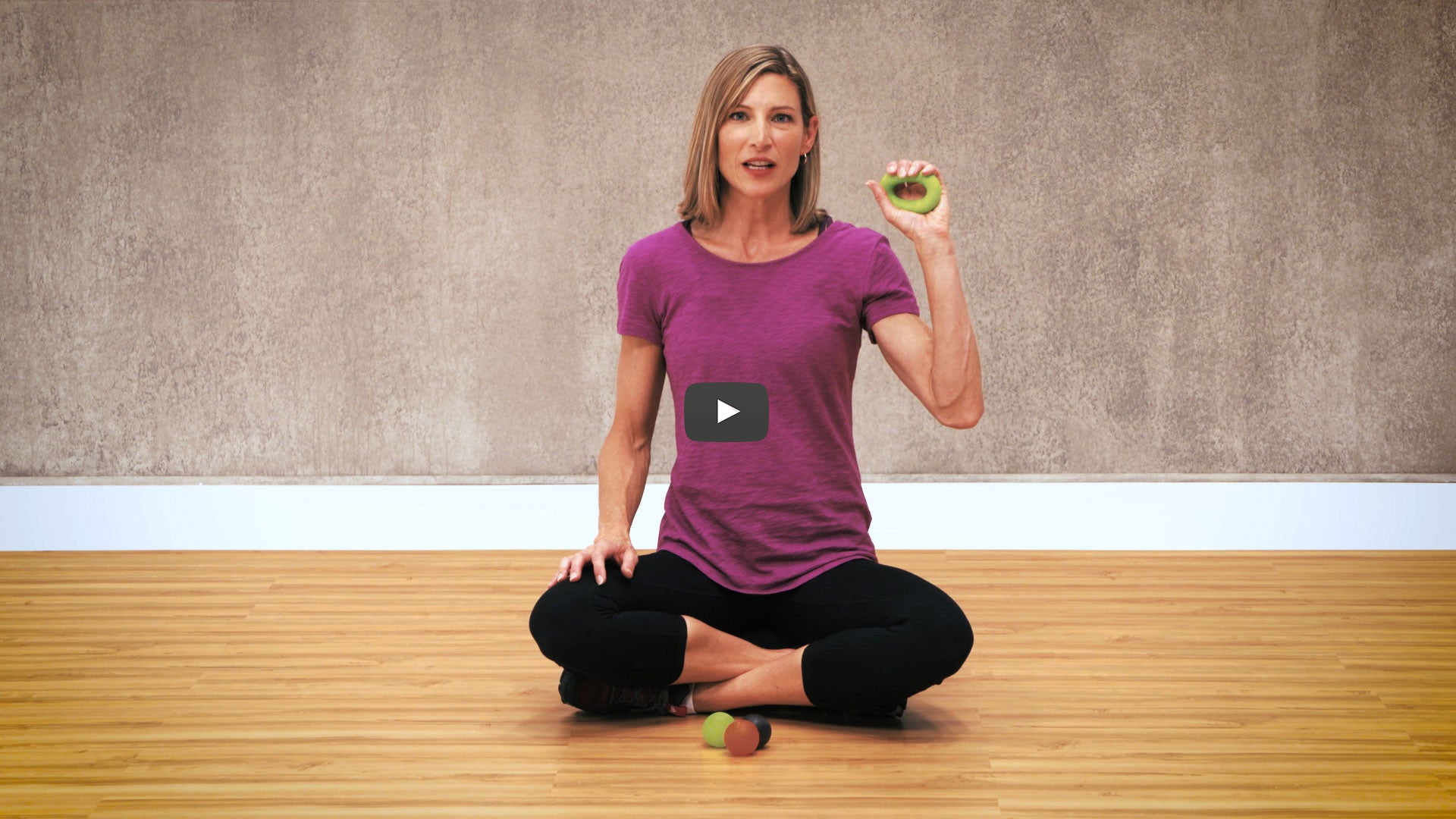 woman holds hand therapy ball