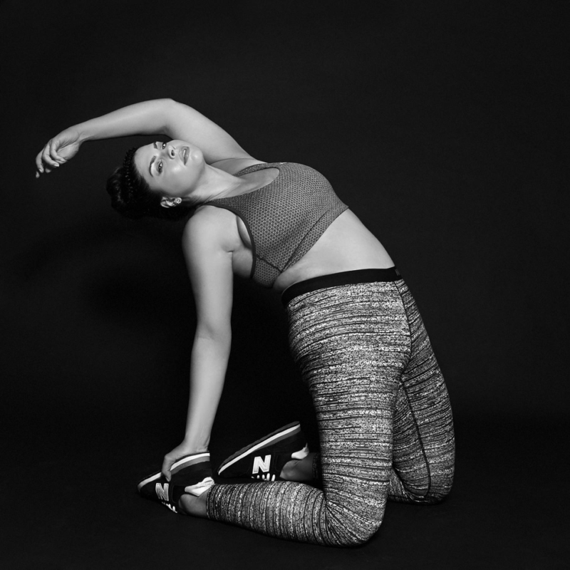 black and white photo of woman stretching in athletic wear