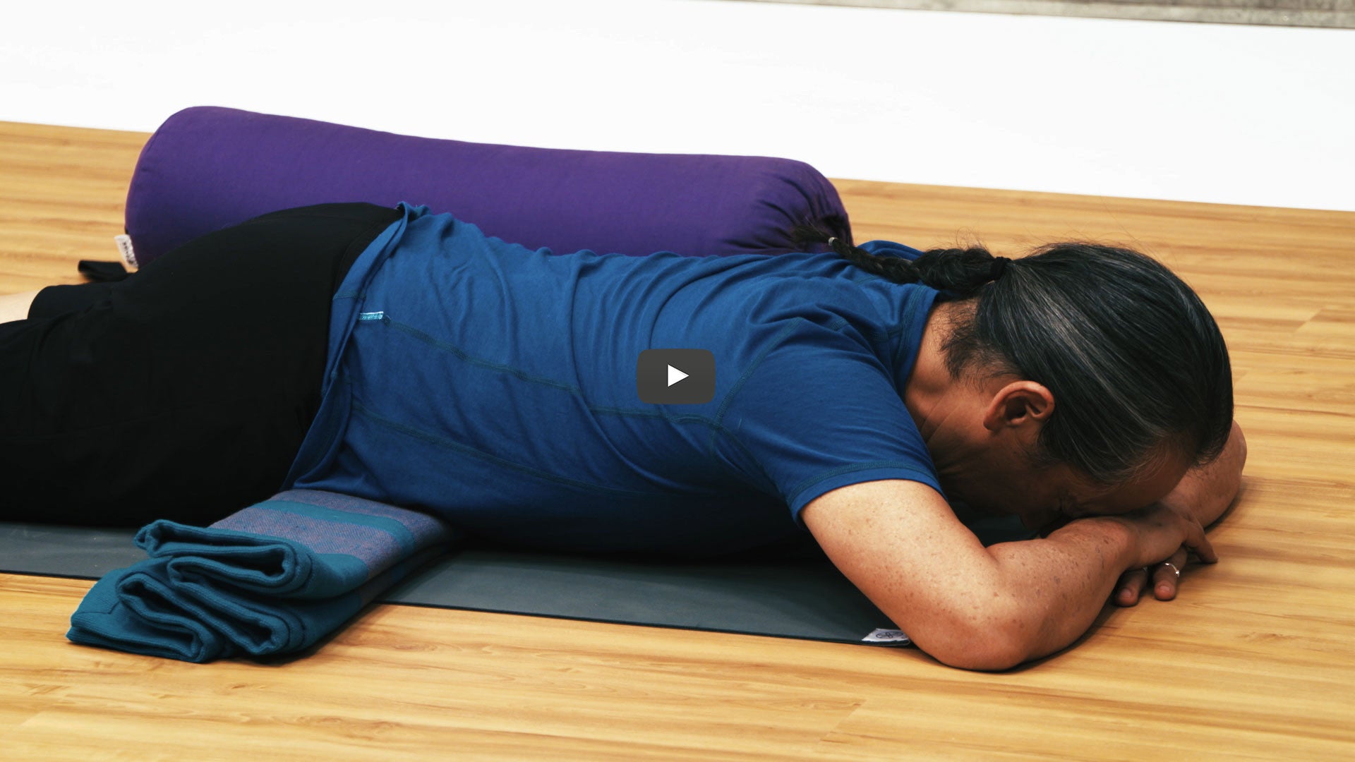 Rodney Yee lays face down on yoga mat
