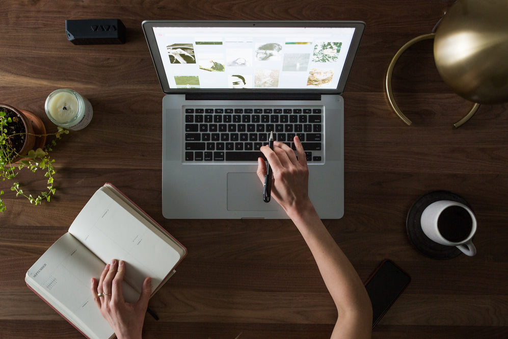 Person sits at a desk with a laptop