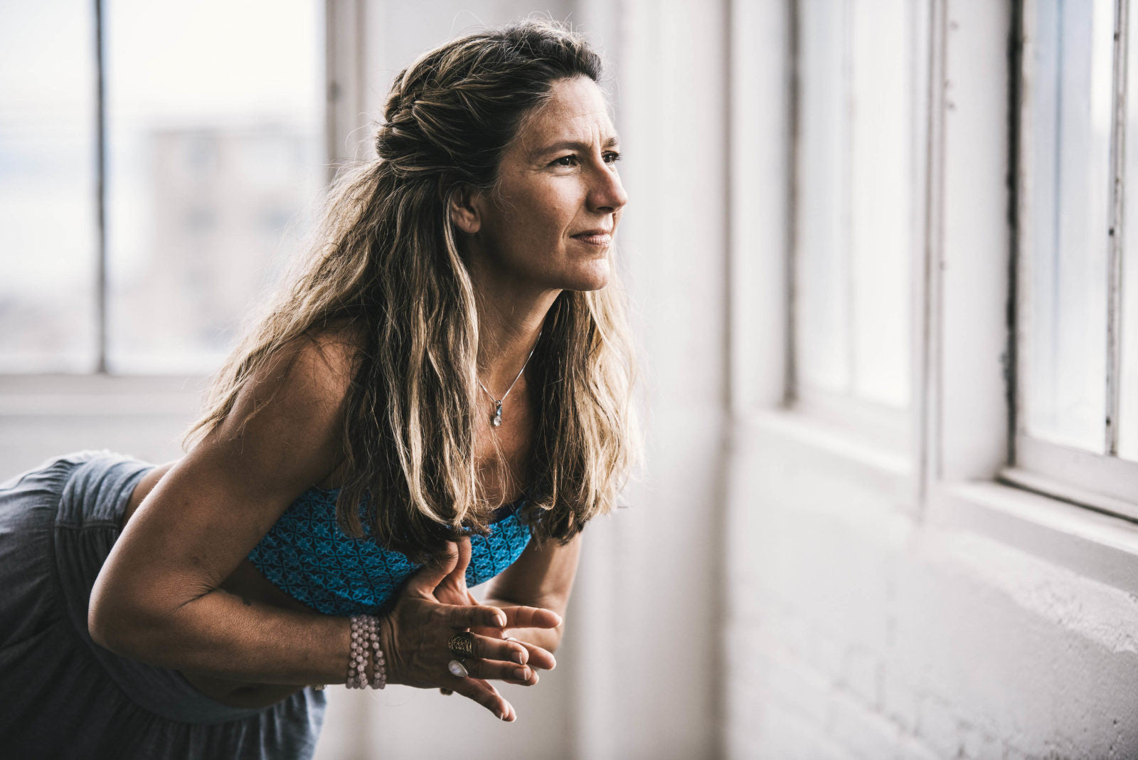 Woman leaning forward with prayer hands