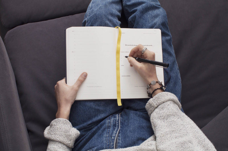 woman writes in journal